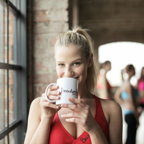 Diverse group of women smiling in a bright yoga studio.